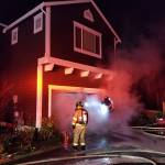 Firefighters extinguish the garage fire in Redmond. The fire would have spread much more without the homes sprinkler system. Photo courtesy of the city of Redmond