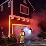 Firefighters extinguish the garage fire in Redmond. The fire would have spread much more without the homes sprinkler system. Photo courtesy of the city of Redmond