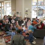 Young children listen to Santa read two Pete The Cat Christmas books. Stephanie Quiroz/staff photo.