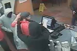 The two suspects wore dark masks to conceal their faces. Redmond police are still investigating this crime. Photos courtesy of the Redmond Police Department