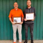 Minuteman Press owner JD Klein and Craig Cutler, lead designer, show off their printing industry awards. Photo courtesy of JC Klein