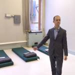 King County Housing and Community Development manager Mike Ellerbrook shows reporters sleeping mats which will be used by shelter residents until beds arrived. The Harborview Hall shelter opened on Dec. 21. Aaron Kunkler/staff photo