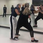 Defense Ninjas instructor Fauzia Lala and COO Kate Warady demonstrate how to break a wrist grab in a workout room at Redmonds DaVinci Academy on Jan. 15. Katie Metzger/staff photo