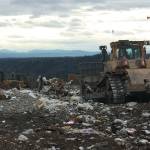 A tractor moves to push trash away from where it was emptied from a cargo trailer atop the Cedar Hills Regional Landfill. An eighth and final section of the landfill is almost ready to come online, extending the life of the landfill through 2028. Aaron Kunkler/staff photo