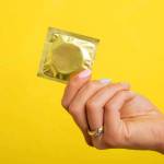 Woman holding a condom. Photo courtesy istockphoto.com