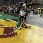 Redmond Mustangs junior Molly Williams, left, competes against Yelm senior Phoenix Dubose, right, in the girls 115-pound tournament semifinal matchup on Feb. 16 at the Mat Classic. Williams earned third place in the 115-pound weight class. Shaun Scott, staff photo