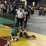 Redmond Mustangs junior Molly Williams, left, competes against Yelm senior Phoenix Dubose, right, in the girls 115-pound tournament semifinal matchup on Feb. 16 at the Mat Classic. Williams earned third place in the 115-pound weight class. Shaun Scott, staff photo