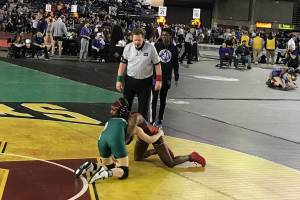 Redmond Mustangs junior Molly Williams, left, competes against Yelm senior Phoenix Dubose, right, in the girls 115-pound tournament semifinal matchup on Feb. 16 at the Mat Classic. Williams earned third place in the 115-pound weight class. Shaun Scott, staff photo