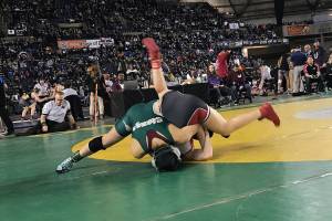 Redmond Mustangs junior wrestler Leah Hiatt, left, pins Teninos Jamiah Christin in just 43 seconds in the girls 115-pound state tournament on Feb. 16 at the Mat Classic at the Tacoma Dome. Hiatt finished in seventh place in the 115-pound weight division. Shaun Scott, staff photo