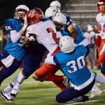 Auburn Riverside defenders bring down Kennedy Catholics Junior Alexander during North Puget Sound League Mountain Division action in Oct. 2018 at Auburn Memorial Stadium. Photo by Rachel Ciampi/Auburn Reporter