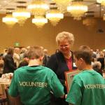 Suzanne Maxon purchases raffle tickets from two Friends of Youth volunteers at the Celebration of Youth event on March 1. Madison Miller/staff photo.