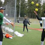 Redmond Highs Kiki Milloy, left, tosses a ball into teammate Jennifer Cummings juggling showcase at practice on Monday. Andy Nystrom / staff photo