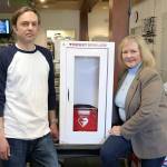 Stephanie Quiroz/staff photo                                 Veterans of Foreign Wars Post 2995 club manager Rob Bailey and lifetime auxiliary member of Post 5694 and guest of the VFW Post 2995 Cecilia Maers with the donated AED and cabinet.