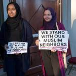 Ranya Ibrahim and Gowiria Yousif hand out signs outside the Muslim Association of Puget Sound mosque in Redmond. Ashley Hiruko/staff photo