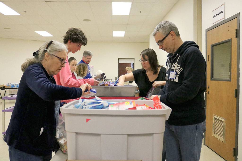 Retail stores in Bellevue, Redmond and Kirkland donated gift cards to purchase items for the hygiene kits and pantry packs. Stephanie Quiroz/staff photo