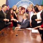 Gov. Jay Inslee shakes hands with Dinah Griffey after signing Senate Bill 5649 on April 19. The law revises the statute of limitations for sex crimes. Photo by Emma Epperly, WNPA Olympia News Bureau