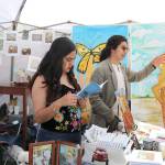 Stephanie Quiroz/staff photo                                 An attendee visits a booth at the Cinco de Mayo festival at the Downtown Park on May 5.