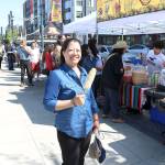 Elizabeth Lee from Redmond eating Mexican grilled corn at the Cinco de May festival at the Downtown Park on May 5. Stephanie Quiroz/staff photo