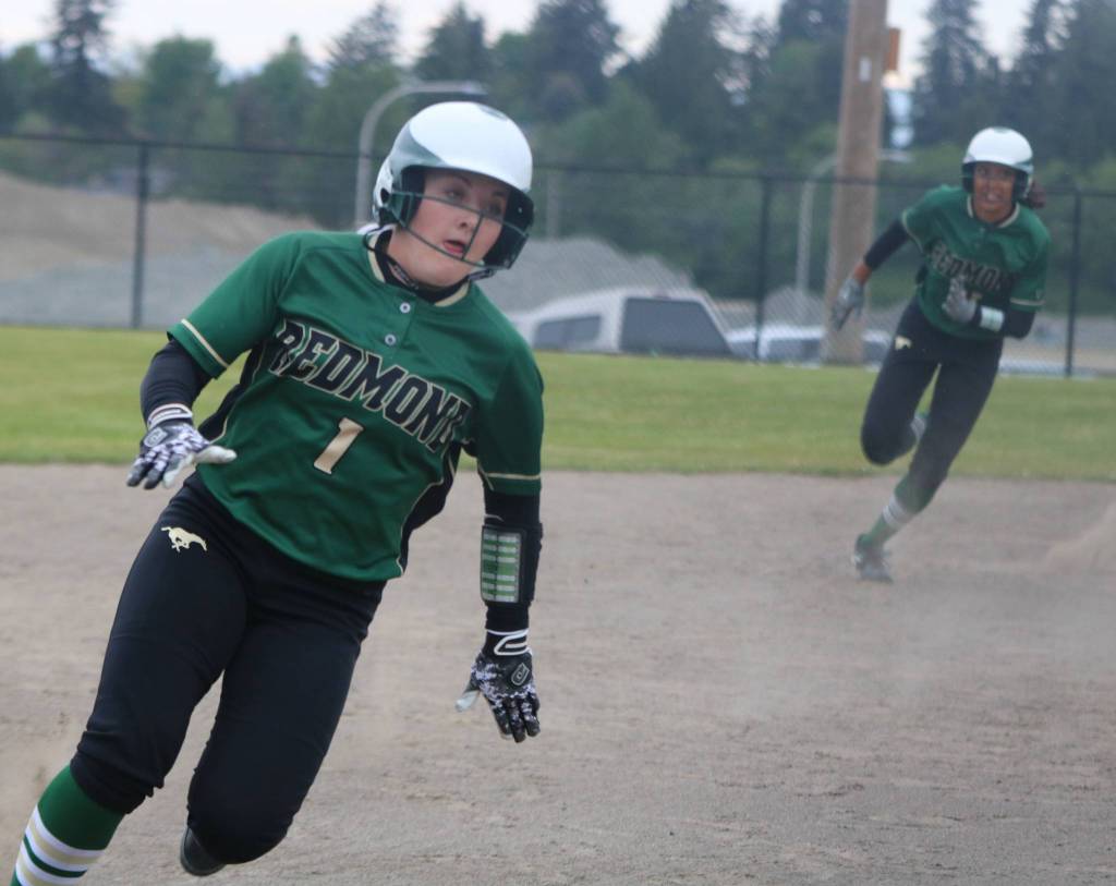 Haley Hanson rounds third to score with Kiki Milloy ripping past second on her way to scoring as well against Newport. Andy Nystrom / staff photo