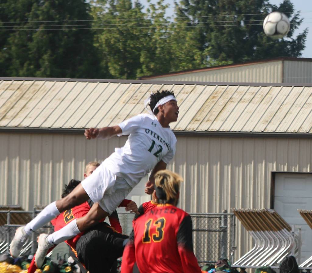 Overlakes Trey Rudolph flies high for a header in the semifinals. Andy Nystrom/ staff photo