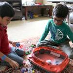 Stephanie Quiroz/staff photo                                 Siddhant Singh shows his 4-year-old brother how to use a beyblade.