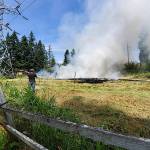 Michael Snook grabbed a water hose to help put out the fires. Photo courtesy of Sue Mitchell
