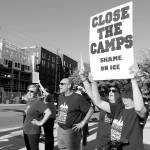 Demonstrators hold their signs at the intersection of Redmond Way and 161st Avenue Northeast, near Downtown Park, on July 12. Stephanie Quiroz/staff photo