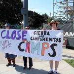From left, Nicole Ricca, Joan Yim and Amanda Karim hold sign that says Close the Camps at the July 12 Lights for Liberty Vigil.