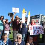Eastsiders hold their posters on July 12 at the Lights for Liberty Vigil to protest the inhumane conditions faced by migrants. Stephanie Quiroz/staff photo