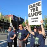Demonstrators hold their signs at the intersection of Redmond Way and 161st Avenue Northeast, near Downtown Park, on July 12. Stephanie Quiroz/staff photo