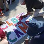 Protestors sign a Close The Camps banner that was delivered to the offices of Sen. Patty Murray (D-WA), Sen. Maria Cantewell (D-WA) and Rep. Suzane DelBene (WA-01). Stephanie Quiroz/staff photo