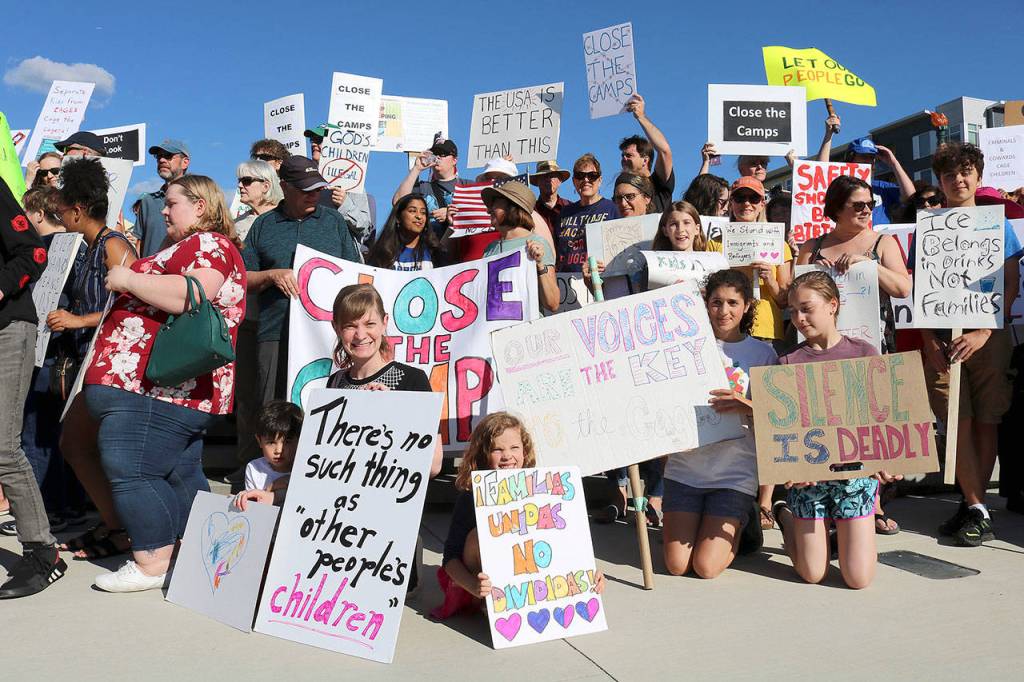 Stephanie Quiroz/staff photos                                 Eastsiders joined the Lights for Liberty: A Vigil to End Human Concentration Camps for a peaceful protest and sign waving at Redmond Downtown Park on July 12.