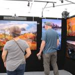 Spectators look at art at the 10th annual Redmond Arts Festival on July 12. Stephanie Quiroz/staff photo