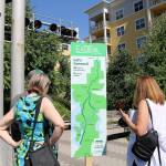 Attendees take a closer look at the new Eastrail logo and tagline, Lets Connect on July 20 in Redmond. Stephanie Quiroz/staff photo