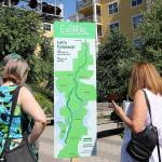 Attendees take a closer look at the new Eastrail logo and tagline, Lets Connect on July 20 in Redmond. Stephanie Quiroz/staff photo