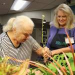 Overlake Terrace resident Nadine Harman helps prune the plants. Stephanie Quiroz/staff photo