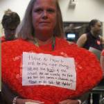 Peg Jatekar, a healthroom secretary at Laura Ingalls Wilder Elementary School, held a plush heart with a handwritten note attached at the school board meeting. The note read Have a heart and do the right thing…We are the faces of the school. We are usually the first and last face parents and students see. Treat us as such. We matter! Madison Miller/staff photo