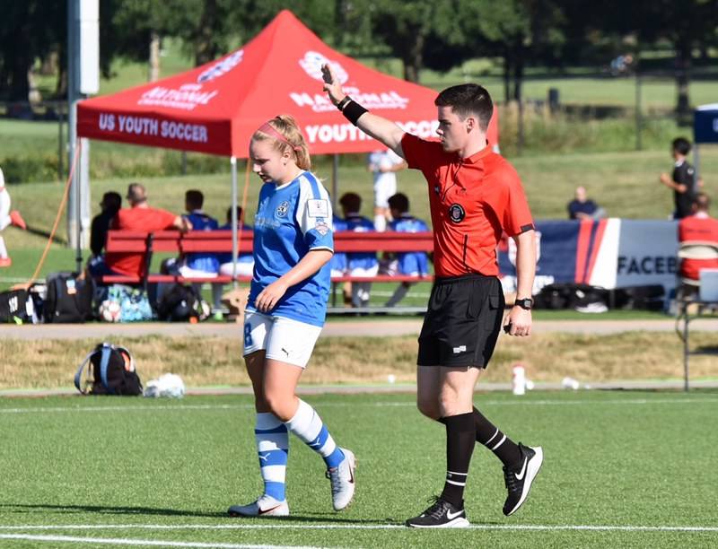 Redmond High alumnus Jordan Price referees a youth soccer match. Photo courtesy of Washington Youth Soccer
