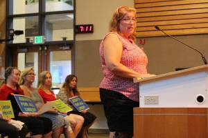 Melody Kieffer, an office manager at Laura Ingalls Wilder Elementary School, addresses the school board on Aug. 12. Madison Miller/staff photo