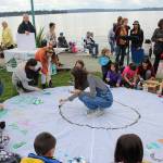Amelia Hawkins leads the kids in painting a donated parachute at Fridays climate strike. Madison Miller/staff photo