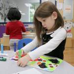 Preschooler Avery tests a paint crayon during the 12th annual Goddard School toy test in Redmond.
