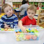Preston (left) and Beckett play with a story making toy during the 12th annual Goddard School toy test in Redmond. Stephanie Quiroz/staff photo