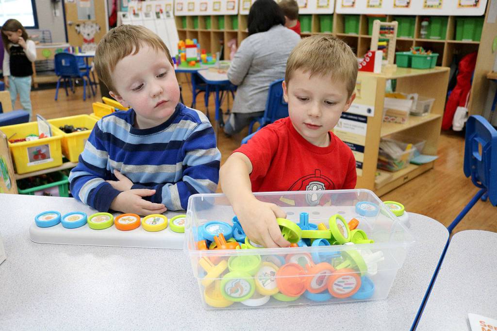 Preston (left) and Beckett play with a story making toy during the 12th annual Goddard School toy test in Redmond. Stephanie Quiroz/staff photo