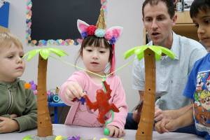 Stephanie Quiroz/staff photos                                 From left: Easton, Emma, Nate Yoker, and Vaibhav test a monkey game during the Goddard School toy test in Redmond.