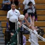 At left, Redmonds Bhavya Garlapati attacks the net against North Creeks Jenna Howard and Grace Medjo during the Jaguars 3-0 volleyball win on Oct. 7. The referee is Raiz Kanji. Photo courtesy of Dale Garvey