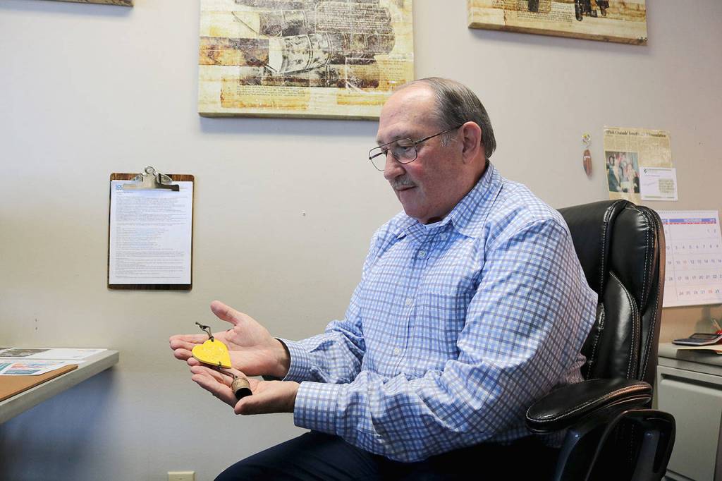 Stephanie Quiroz/staff photo                                Paul Brown looks at his Be Kind bell he received following the Marysville Pilchuck High School shooting.