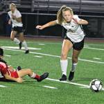 Newports Ellen Akopyan falls to the pitch as Redmonds Aspen Sullivan blazes by the Knight. Andy Nystrom/ staff photo