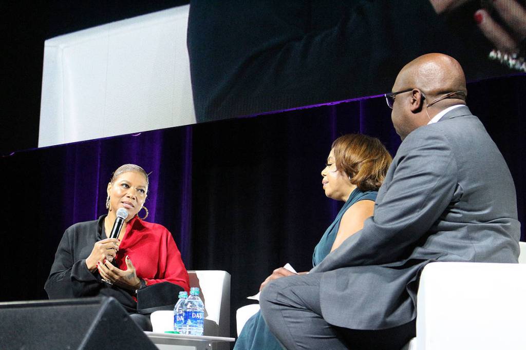Madison Miller/staff photo                                 Queen Latifah discusses how poverty should be talked about more at the 24th annual Reaching Out luncheon with co-chairs Lynne Varner and Paul Hollie.
