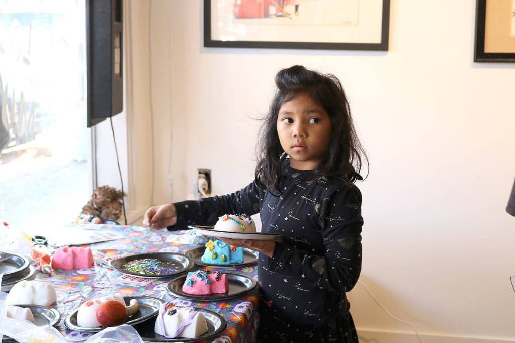 Lumbini, 8, from Sammamish decorates a sugar skull at the Día de los Muertos event at the Centro Cultural Mexicano in Redmond on Nov. 2. Stephanie Quiroz/staff photo
