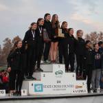 Redmond Highs girls cross-country team stands atop the victory podium at state. From left, coach Carson Potter, Neha Ramanath, Lili Hargreaves, Chloe Connolly, Zephyr Tao, Lauren Lehr, Sophia Dahl, Joanna Gormley, Anna Petrbokova, coach Pete Whitmore and Lea Bodmer. Courtesy of Christopher Dahl